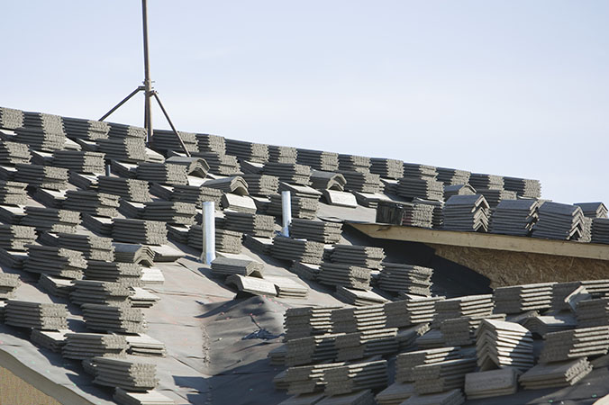 Stacks of tiles on house roof